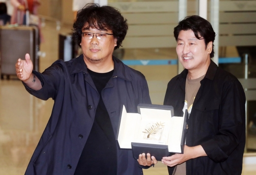 영화 '기생충'으로 한국 영화 최초로 황금종려상을 수상한 봉준호 감독과 주연배우 송강호가 지난 27일 오후 인천국제공항을 통해 귀국하며 상패를 들어보이고 있다. /사진=머니투데이 DB