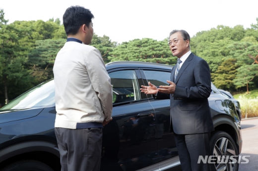 문재인 대통령이 27일 오후 청와대 녹지원 앞에서 박계일 현대차 공정기술과장으로부터 대통령 전용차로 도입된 수소차(넥쏘)에 대한 설명을 듣고 있다. /사진=뉴시스(청와대 제공)