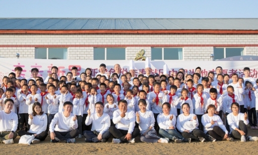 김태호 신라면세점 코리아사업부장 전무와 왕시셩(王希胜) 시먼즈 초등학교 교장 등 봉사활동을 펼친 관계자들과 초등학생들이 단체사진을 찍고 있다. /사진제공=호텔신라