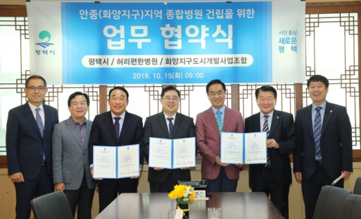 평택시는 15일 실시한 언론브리핑을 통해 서부 지역 응급 의료센터 기능을 수행할 수 있는 종합병원 건립을 위해 허리편한병원, 화양지구 도시개발사업조합과 업무협약을 체결했다고 밝혔다(왼쪽부터 백운기 안중출장소장, 김영호 평택보건소장, 최선철 조합장, 양용호 병원장, 정장선 시장, 권영화 의장, 이종한 시의원). / 사진제공=평택시