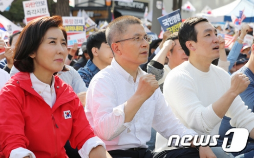 황교안 자유한국당 대표(가운데)와 나경원 원내대표(왼쪽) 등 참석자들이 지난 19일 서울 광화문 광장에서 열린 '국정대전환 촉구 국민보고대회'에서 구호를 외치고 있다. /사진=뉴스1
