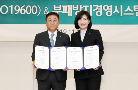 강태희(왼쪽) 하나금융지주 준법감시인이 13일 오전 서울 명동 본점에서 한국경영인증원으로부터 준법경영시스템(ISO19600) 및 부패방지경영시스템(ISO37001) 국제 표준 인증서를 수여받은 뒤 황은주 원장과 함께 기념촬영을 하고 있다./사진=하나금융