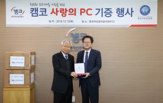 신흥식 캠코(한국자산관리공사) 경영본부장(오른쪽)과 허완 한국IT복지진흥원 사무총장(왼쪽)이 12월12일 BIFC 46층 중회의실에서 열린 '정보화 소외계층 지원을 위한 캠코 사랑의 PC 기증 행사'에서 기념촬영을 하고 있다./사진제공=캠코